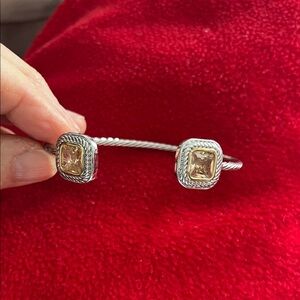 Silver colored bracelet with gold color, gems, designer style